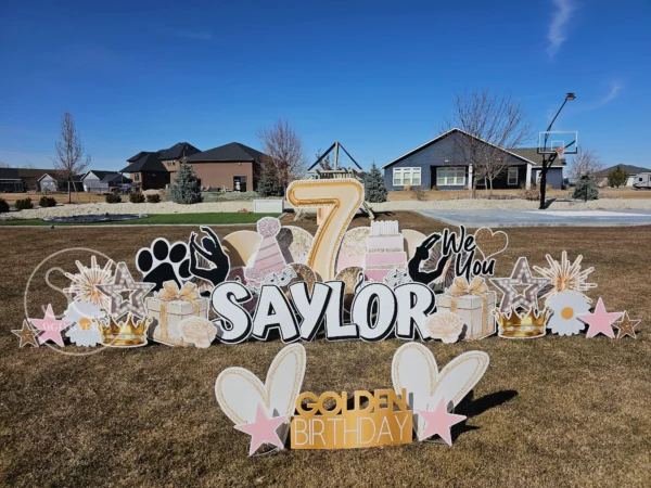 An image of a yard sign with a big number 7, the phrase "Saylor Golden Birthday" and other graphics around it.