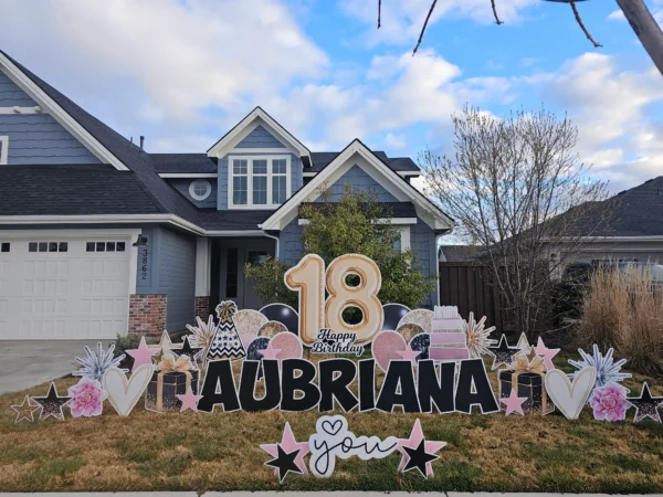 An image of a yard sign with a big number 18, the phrase "Happy Birthday Aubriana" and other graphics around it.