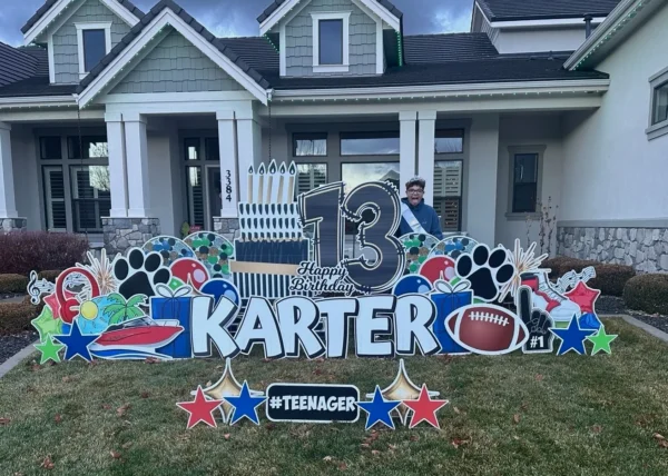 An image of a yard sign with a big number 13, the phrase "Happy Birthday Karter" and other graphics around it.